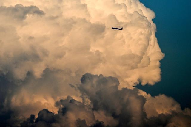 A Boeing 777-3B5(ER) aircraft by Korean Air airline flies at sunset in front of clouds shortly after take-off from Frankfurt International Airport in Frankfurt am Main, western Germany, on May 15, 2026.  (Photo by Kirill KUDRYAVTSEV / AFP)