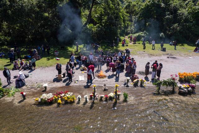 Mam Maya indigenous people take part in the 'Prayer for Rain' ceremony -to bless the crops- on the shore of Chicabal Lake, formed in the crater of an extinct volcano and which they consider a sacred place, in San Martin Sacatepequez, Quetzaltenango, Guatemala, on May 14, 2026. (Photo by Carlos ALONZO / AFP)