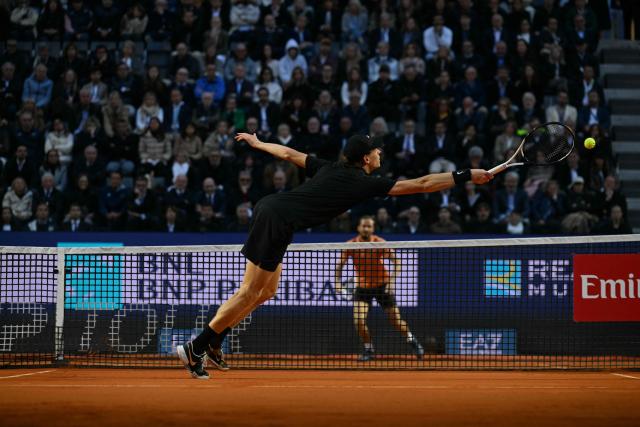 Italy's Jannik Sinner stretches to return the ball to Russia's Daniil Medvedev during their semi-final at the ATP Rome Open tennis tournament at Foro Italico in Rome on May 15, 2026. (Photo by Tiziana FABI / AFP)