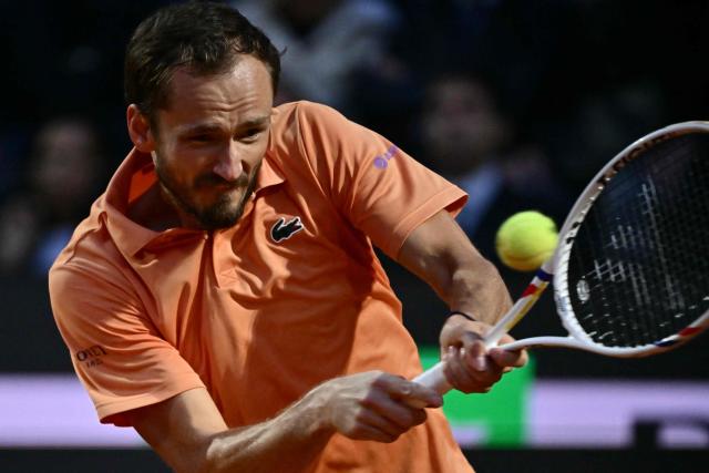 Russia's Daniil Medvedev hits a return to Italy's Jannik Sinner during their semi-final at the ATP Rome Open tennis tournament at Foro Italico in Rome on May 15, 2026. (Photo by Filippo MONTEFORTE / AFP)