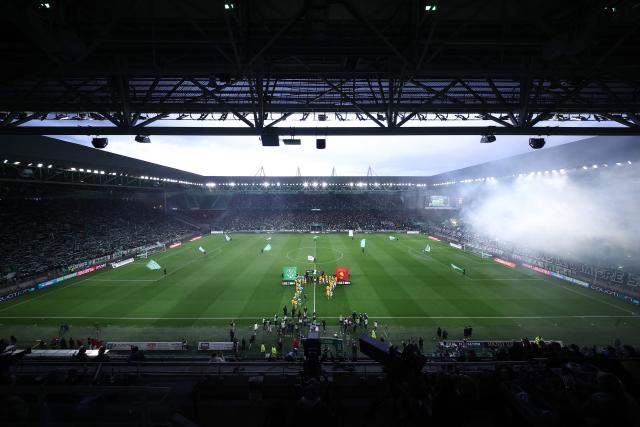 Players arrive on the pitch ahead of the French L1-L2 playoff second leg football match between AS Saint-Etienne and Rodez at the stade Geoffroy Guichard in Saint-Etienne, south-eastern France on May 15, 2026. (Photo by Alex MARTIN / AFP)