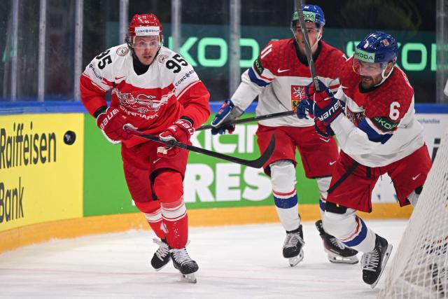 Denmark's forward #95 Nick Olesen (L) and Czech Republic's defender #6 Michal Kempny (R) fight for the puck during the group B match between Czech Republic and Denmark at the IIHF Ice Hockey Men's World Championship in the BFC Arena, Fribourg, on May 15, 2026. (Photo by Fabrice COFFRINI / AFP)