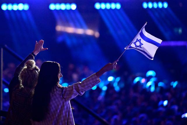 Fans wave an Israeli flag prior to the start of the dress rehearsal for the grand final of the Eurovision Song Contest 2026 (ESC) at Wiener Stadthalle in Vienna, Austria on May 15, 2026. (Photo by Tobias SCHWARZ / AFP)
