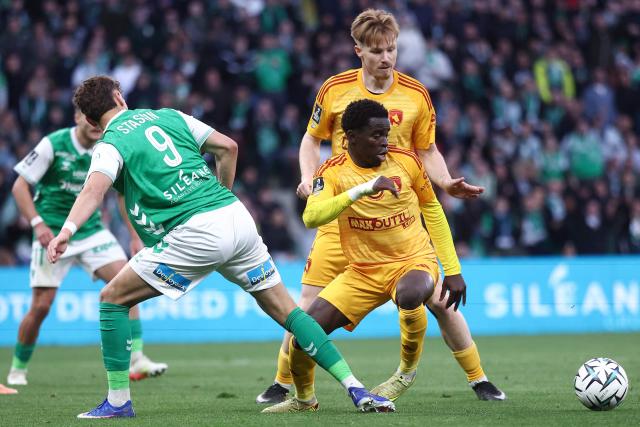 Saint Etienne’s Belgium forward Lucas Stassin (L) fights for the ball with Rodez's Cameroonian midfielder #08 Wilitty Younoussa during the French L1-L2 playoff second leg football match between AS Saint-Etienne and Rodez at the stade Geoffroy Guichard in Saint-Etienne, south-eastern France on May 15, 2026. (Photo by Alex MARTIN / AFP)