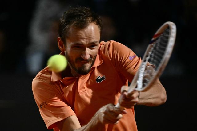 Russia's Daniil Medvedev hits a return to Italy's Jannik Sinner during their semi-final at the ATP Rome Open tennis tournament at Foro Italico in Rome on May 15, 2026. (Photo by Filippo MONTEFORTE / AFP)