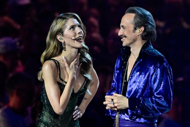 Austrian presenters Michael Ostrowski and Victoria Swarovski stand on stage during the dress rehearsal for the grand final of the Eurovision Song Contest 2026 (ESC) at Wiener Stadthalle in Vienna, Austria on May 15, 2026. (Photo by Tobias SCHWARZ / AFP)