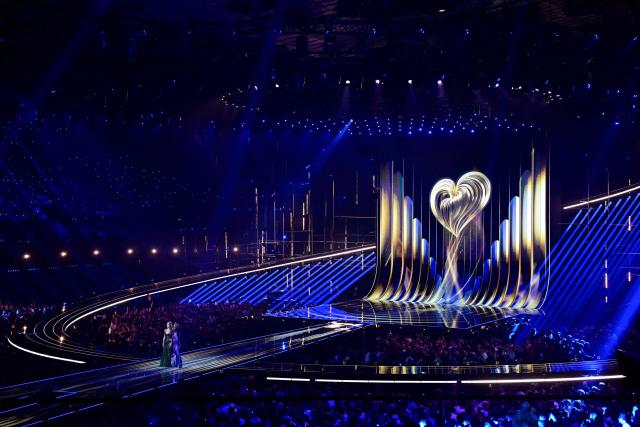Austrian presenters Michael Ostrowski and Victoria Swarovski stand on stage during the dress rehearsal for the grand final of the Eurovision Song Contest 2026 (ESC) at Wiener Stadthalle in Vienna, Austria on May 15, 2026. (Photo by Tobias SCHWARZ / AFP)