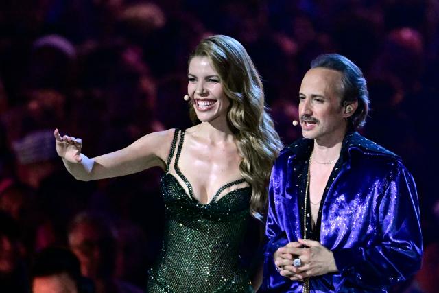Austrian presenters Michael Ostrowski and Victoria Swarovski stand on stage during the dress rehearsal for the grand final of the Eurovision Song Contest 2026 (ESC) at Wiener Stadthalle in Vienna, Austria on May 15, 2026. (Photo by Tobias SCHWARZ / AFP)