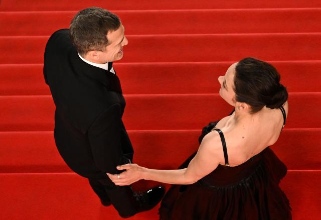 French director and screenwriter Guillaume Canet (L) and French actress Marion Cotillard leaves after the screening of the film "Karma" at the 79th edition of the Cannes Film Festival in Cannes, southern France on May 15, 2026. (Photo by Antonin THUILLIER / AFP)