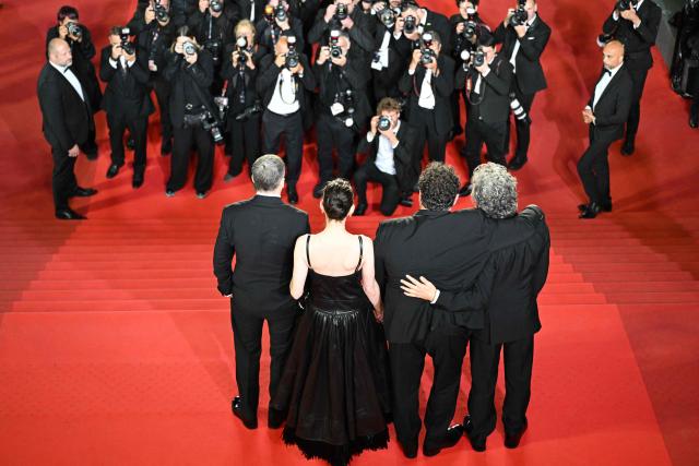 The team of the film "Karma" pose for photographers after its screening at the 79th edition of the Cannes Film Festival in Cannes, southern France on May 15, 2026. (Photo by Antonin THUILLIER / AFP)