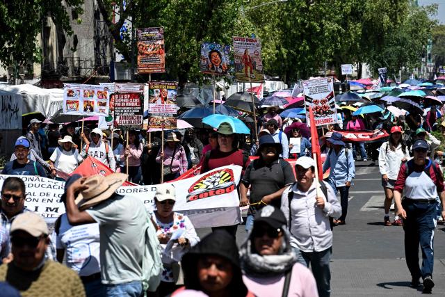Teachers, members of the National Coordinator of Education Workers (CNTE), take part in a protest march demanding wage increases on Teachers' Day, in Mexico City, on May 15, 2026. (Photo by Yuri CORTEZ / AFP)
