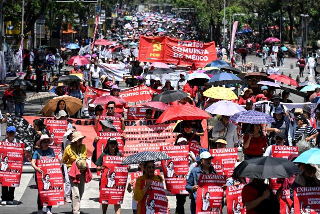 Teachers, members of the National Coordinator of Education Workers (CNTE), take part in a protest march demanding wage increases on Teachers' Day, in Mexico City, on May 15, 2026. (Photo by Yuri CORTEZ / AFP)