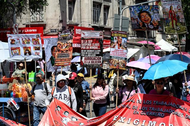 Teachers, members of the National Coordinator of Education Workers (CNTE), take part in a protest march demanding wage increases on Teachers' Day, in Mexico City, on May 15, 2026. (Photo by Yuri CORTEZ / AFP)