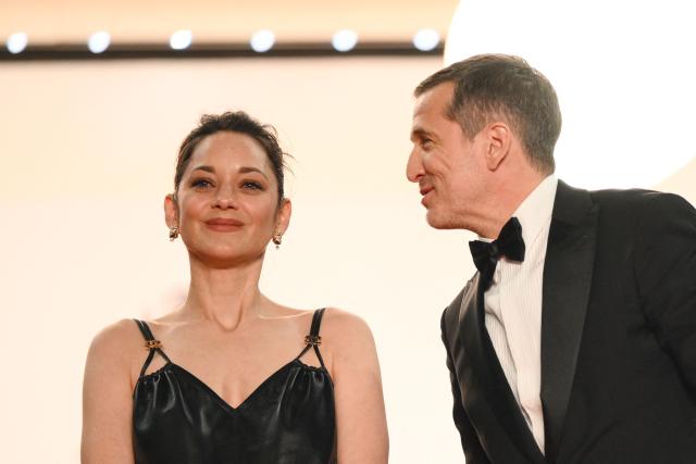 French actress Marion Cotillard and French director and screenwriter Guillaume Canet leave after the screening of the film "Karma" at the 79th edition of the Cannes Film Festival in Cannes, southern France on May 15, 2026. (Photo by Olivier CHASSIGNOLE / AFP)