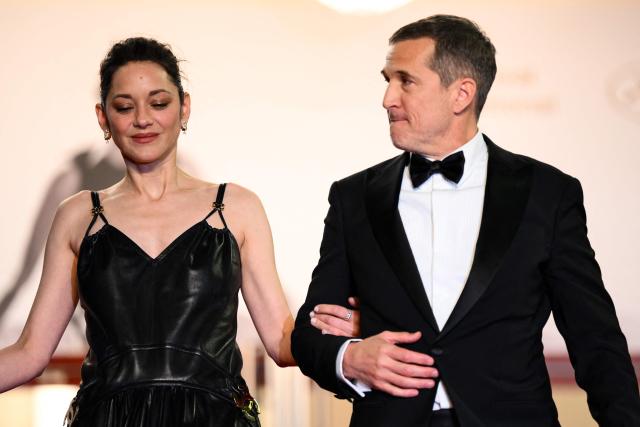 French actress Marion Cotillard and French director and screenwriter Guillaume Canet leave after the screening of the film "Karma" at the 79th edition of the Cannes Film Festival in Cannes, southern France on May 15, 2026. (Photo by Olivier CHASSIGNOLE / AFP)
