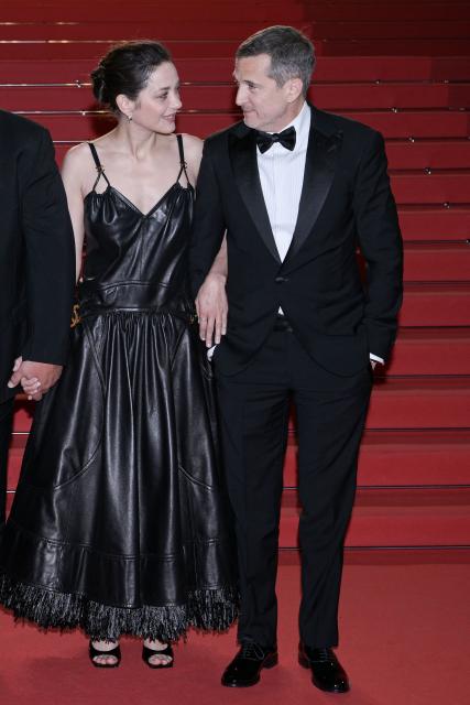 French actress Marion Cotillard and French director and screenwriter Guillaume Canet leave after the screening of the film "Karma" at the 79th edition of the Cannes Film Festival in Cannes, southern France on May 15, 2026. (Photo by Olivier CHASSIGNOLE / AFP)