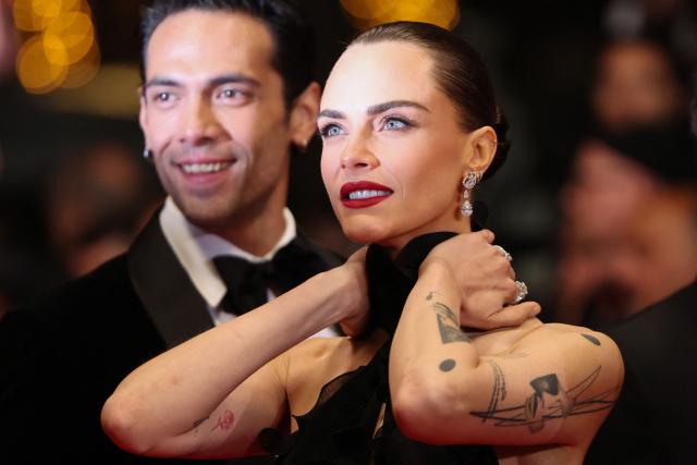 British model and actress Cara Delevingne and Mexican actor Diego Calva arrive for the screening of the film "Club Kid" at the 79th edition of the Cannes Film Festival in Cannes, southern France on May 15, 2026. (Photo by Thibaud MORITZ / AFP)