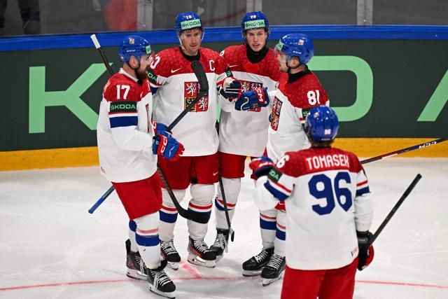 Czech Republic's forward #10 Roman Cervenka celebrates with teammate after scoring his team's first goal during the IIHF Ice Hockey Men's World Championship  first round group B ice hockey match between Czech Republic and Denmark at  at BFC Arena, in Fribourg, Switzerland, on May 15, 2026. (Photo by Fabrice COFFRINI / AFP)