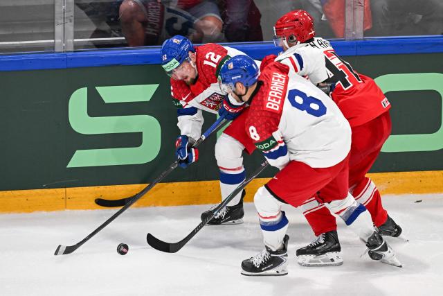 Czech Republic's forward #12 Jiri Cernoch (rear L), Denmark's defender #41 Jesper Jensen Aabo (R) and Czech Republic's forward #8 Ondrej Beranek (front R) fight for the puck  during the IIHF Ice Hockey Men's World Championship  first round group B ice hockey match between Czech Republic and Denmark at  at BFC Arena, in Fribourg, Switzerland, on May 15, 2026. (Photo by Fabrice COFFRINI / AFP)
