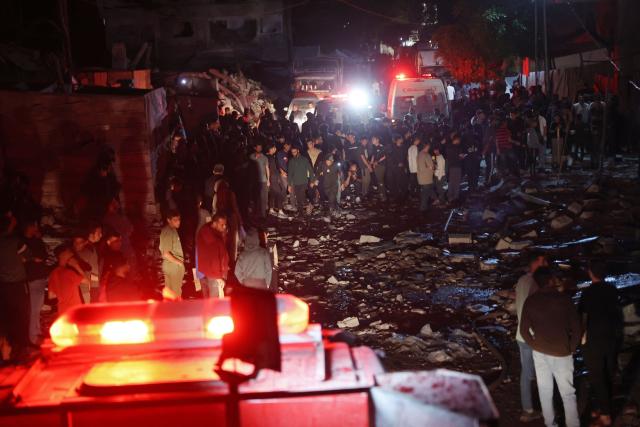 First responders and residents gather at the site of an Israeli strike in the Rimal neighbourhood of Gaza City on May 15, 2026. Israel said on May 15 that it carried out a strike in Gaza targeting Ezzedine Al-Haddad, who it described as chief of the armed wing of Palestinian movement Hamas. Since Hamas's October 7, 2023 attack on Israel, the Israeli military and intelligence services have waged an extensive campaign targeting the group's senior political leaders and militant commanders in Gaza and across the region. (Photo by Omar AL-QATTAA / AFP)