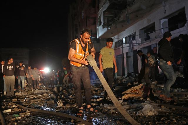 A first responder holds a waterpipe at the site of an Israeli strike in the Rimal neighbourhood of Gaza City on May 15, 2026. Israel said on May 15 that it carried out a strike in Gaza targeting Ezzedine Al-Haddad, who it described as chief of the armed wing of Palestinian movement Hamas. Since Hamas's October 7, 2023 attack on Israel, the Israeli military and intelligence services have waged an extensive campaign targeting the group's senior political leaders and militant commanders in Gaza and across the region. (Photo by Omar AL-QATTAA / AFP)