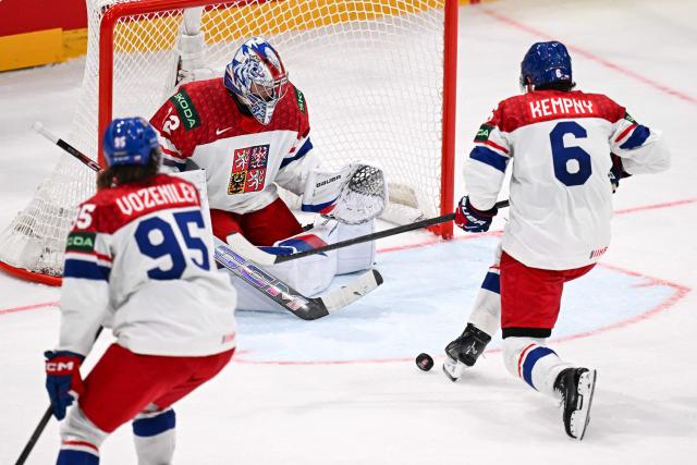 Czech Republic's defender #6 Michal Kempny (R) deflects a puck next Czech Republic's goalkeeper #32 Josef Korenar  during the IIHF Ice Hockey Men's World Championship  first round group B ice hockey match between Czech Republic and Denmark at  at BFC Arena, in Fribourg, Switzerland, on May 15, 2026. (Photo by Fabrice COFFRINI / AFP)