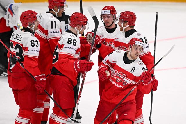Denmark's players celebrates after scoring their team's first goal during the IIHF Ice Hockey Men's World Championship  first round group B ice hockey match between Czech Republic and Denmark at  at BFC Arena, in Fribourg, Switzerland, on May 15, 2026. (Photo by Fabrice COFFRINI / AFP)