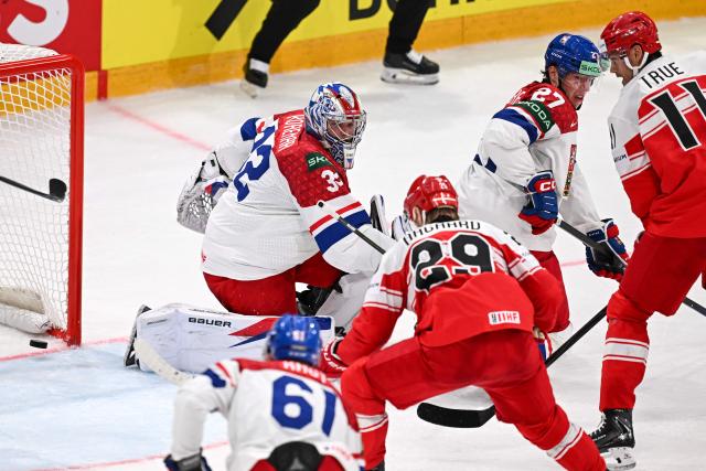 Czech Republic's goalkeeper #32 Josef Korenar misses to save the puck and Denmark's Mikkel Aagaard scores his first team goal during the IIHF Ice Hockey Men's World Championship  first round group B ice hockey match between Czech Republic and Denmark at  at BFC Arena, in Fribourg, Switzerland, on May 15, 2026. (Photo by Fabrice COFFRINI / AFP)