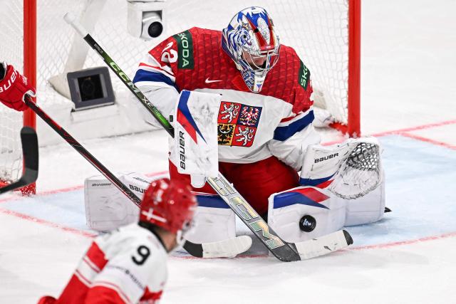 Czech Republic's goalkeeper #32 Josef Korenar stops the puck from entering the goal cage during the IIHF Ice Hockey Men's World Championship  first round group B ice hockey match between Czech Republic and Denmark at  at BFC Arena, in Fribourg, Switzerland, on May 15, 2026. (Photo by Fabrice COFFRINI / AFP)