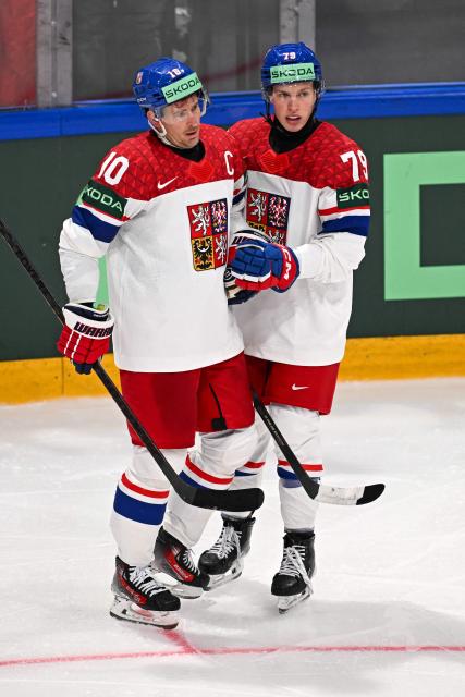 Czech Republic's forward #10 Roman Cervenka celebrates scoring his team's third goal with teammate defender Thomas Galvas during the IIHF Ice Hockey Men's World Championship  first round group B ice hockey match between Czech Republic and Denmark at  at BFC Arena, in Fribourg, Switzerland, on May 15, 2026. (Photo by Fabrice COFFRINI / AFP)