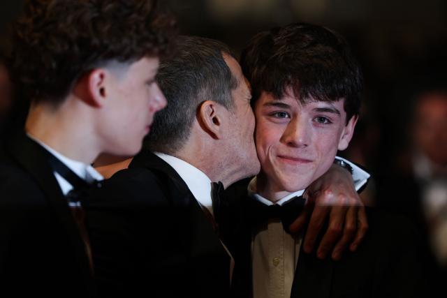 French director and screenwriter Guillaume Canet (C) embraces French actor Hugo Trophardy (R) after the screening of the film "Karma" at the 79th edition of the Cannes Film Festival in Cannes, southern France on May 15, 2026. (Photo by Sameer AL-DOUMY / AFP)