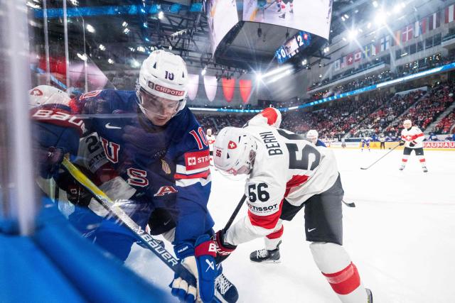 USA's forward #10 James Hagens (L) fights for the puck with Switzerland's defender #56 Tim Berni (R) during the IIHF Ice Hockey Men's World Championship first round group A ice hockey match between USA and Switzerland at the Swiss Life Arena, in Zurich, on May 15, 2026. (Photo by ENNIO LEANZA / AFP)