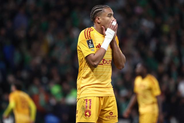Rodez's Guadeloupean forward #11 Tairyk Arconte reacts after missing a goal scoring opportunity during the French L1-L2 playoff second leg football match between AS Saint-Etienne and Rodez at the stade Geoffroy Guichard in Saint-Etienne, south-eastern France, on May 15, 2026. (Photo by Alex MARTIN / AFP)
