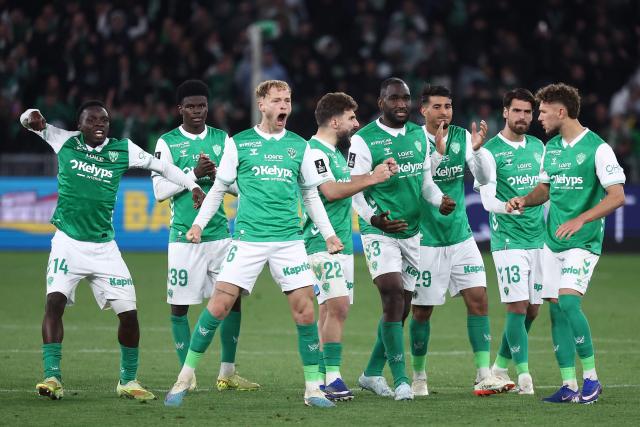 Saint-Etienne's players celebrate their victory after a penalty shoot out at the end of the French L1-L2 playoff second leg football match between AS Saint-Etienne and Rodez at the stade Geoffroy Guichard in Saint-Etienne, south-eastern France, on May 15, 2026. (Photo by Alex MARTIN / AFP)