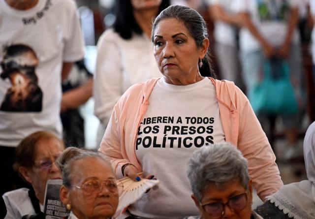 Relatives of political prisoners attend a mass in honour of the late political prisoner Victor Quero Navas, in Caracas on May 15, 2026. Venezuela's prisons ministry last May 7 acknowledged the death in custody of political prisoner Victor Hugo Quero Navas, 51, nearly a year after his passing and after his mother spent months searching for him. (Photo by Juan BARRETO / AFP)