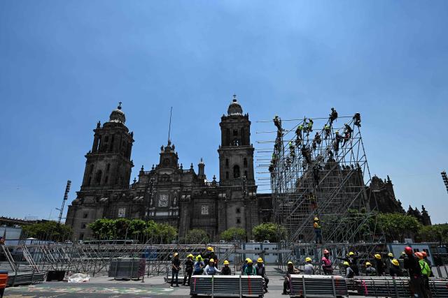 Workers set up scaffolding for the assembly of giant screens and stages of the FIFA Fan Festival at Zocalo square ahead of the World Cup in Mexico City on May 15, 2026. Mexico will co-host the biggest World Cup in history along with the United States and Canada from June 11 to July 19, 2026. (Photo by Yuri CORTEZ / AFP)