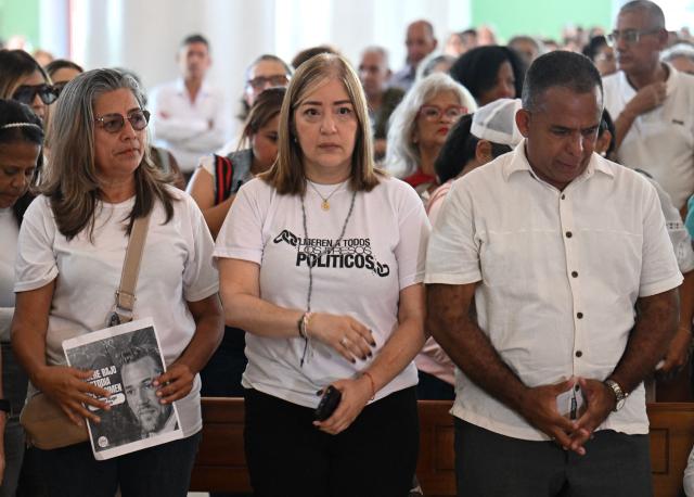 Relatives of political prisoners attend a mass in honour of the late political prisoner Victor Quero Navas, in Caracas on May 15, 2026. Venezuela's prisons ministry last May 7 acknowledged the death in custody of political prisoner Victor Hugo Quero Navas, 51, nearly a year after his passing and after his mother spent months searching for him. (Photo by Juan BARRETO / AFP)