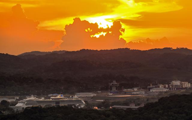 (FILES) The cruise ship Serenade of the Seas (L) transits the Miraflores Locks of the Panama Canal at sunset on April 25, 2026. The Panama Canal Authority, reported on May 15, 2026 that the Panama Canal, through which 5% of the world’s maritime trade passes, is anticipating possible restrictions on ship transit at the end of the year due to the El Niсo phenomenon. (Photo by MARTIN BERNETTI / AFP)