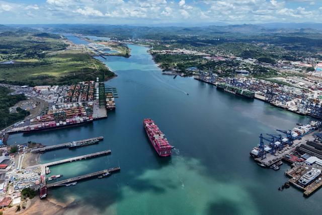 (FILES) Aerial view of the One Contribution container ship sailing under the Tokio flag as it enters the Panama Canal in Panama City on April 21, 2026. The Panama Canal Authority, reported on May 15, 2026 that the Panama Canal, through which 5% of the world’s maritime trade passes, is anticipating possible restrictions on ship transit at the end of the year due to the El Niсo phenomenon. (Photo by MARTIN BERNETTI / AFP)
