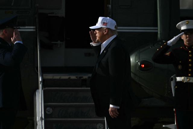 US President Donald Trump salutes before boarding Marine One after landing at Joint Base Andrews in Maryland on May 15, 2026. Trump is returning from Beijing where he met with Chinese President Xi Jinping to discuss trade deals in various sectors. (Photo by Brendan SMIALOWSKI / AFP)