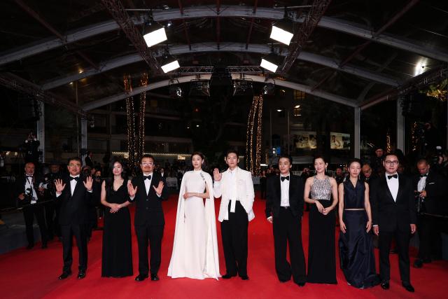 (From 2L) South Korean producer Hailey Yoomin Yang, South Korean director Yeon Sang-Ho, South Korean actor Jun Ji-Hyun, South Korean actor Ji Chang-Wook, South Korean actor Koo Kyo-Hwan, South Korean actress Shin Hyeon-Bin and South Korean actor Kim Shin-Rock arrive for the screening of the film "Gun-Che" (Colony) at the 79th edition of the Cannes Film Festival in Cannes, southern France on May 15, 2026. (Photo by Sameer AL-DOUMY / AFP)