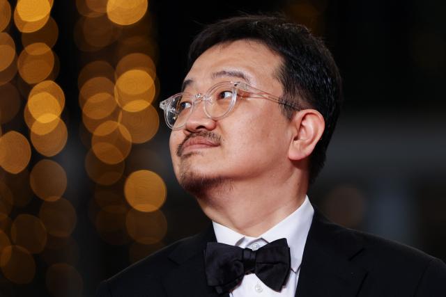 South Korean director Yeon Sang-Ho arrives for the screening of the film "Gun-Che" (Colony) at the 79th edition of the Cannes Film Festival in Cannes, southern France on May 15, 2026. (Photo by Sameer AL-DOUMY / AFP)