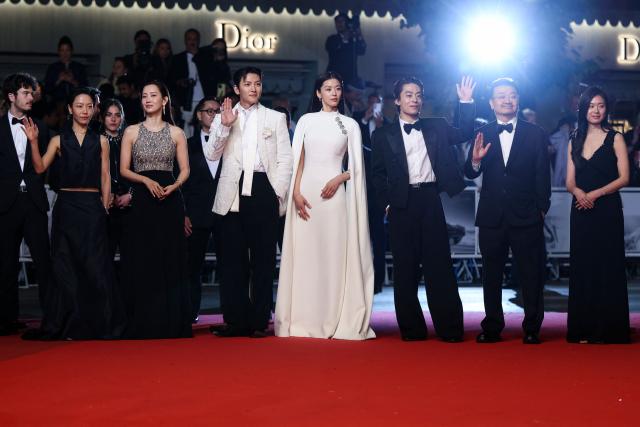 (From 2L) South Korean actor Kim Shin-Rock, South Korean actress Shin Hyeon-Been, South Korean actor Ji Chang-Wook, South Korean actor Jun Ji-Hyun, South Korean actor Koo Kyo-Hwan, South Korean director Yeon Sang-Ho and South Korean producer Hailey Yoomin Yang arrive for the screening of the film "Gun-Che" (Colony) at the 79th edition of the Cannes Film Festival in Cannes, southern France on May 15, 2026. (Photo by Sameer AL-DOUMY / AFP)