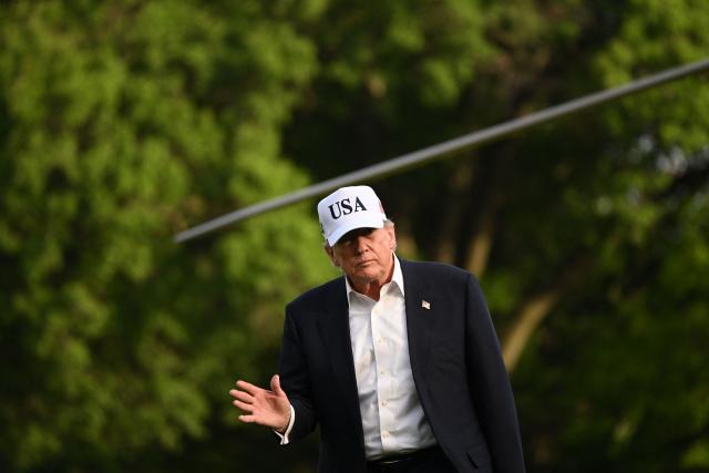 US President Donald Trump waves after stepping off Marine One on the South Lawn of the White House in Washington, DC, on May 15, 2026. Trump is returning from Beijing where he met with Chinese President Xi Jinping to discuss trade deals in various sectors. (Photo by Alex WROBLEWSKI / AFP)