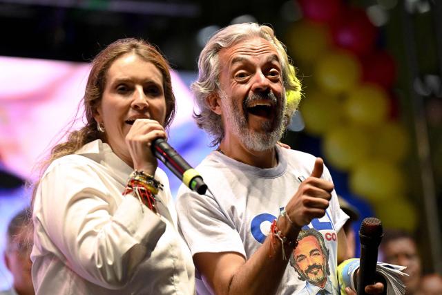 Colombia's presidential candidate Paloma Valencia, of the Centro Democratico party, speaks next to her vice-presidential candidate Juan Daniel Oviedo during a campaign rally in Cali, Colombia on May 15, 2026. Colombia will hold presidential elections on May 31. (Photo by JOAQUIN SARMIENTO / AFP)