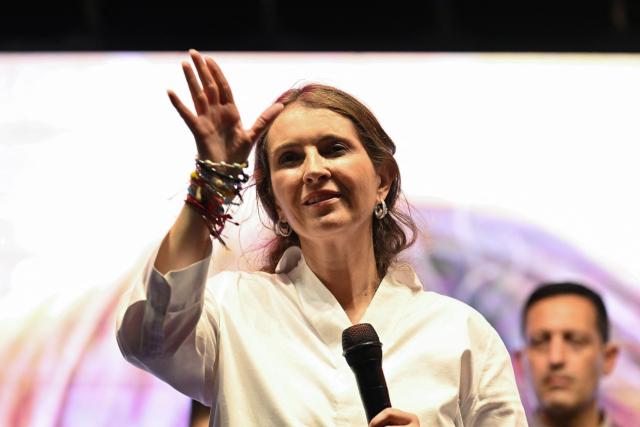 Colombia's presidential candidate Paloma Valencia, of the Centro Democratico party, waves at supporters during a campaign rally in Cali, Colombia on May 15, 2026. Colombia will hold presidential elections on May 31. (Photo by JOAQUIN SARMIENTO / AFP)