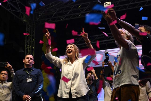 Colombia's presidential candidate Paloma Valencia, of the Centro Democratico party, and her vice-presidential candidate Juan Daniel Oviedo cheer during a campaign rally in Cali, Colombia on May 15, 2026. Colombia will hold presidential elections on May 31. (Photo by JOAQUIN SARMIENTO / AFP)