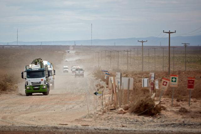 (FILES) Trucks drive along a road in Anelo, Neuquen province, Argentina, in the Vaca Muerta Formation, on November 28, 2019. Argentina's state-owned oil company YPF has applied to participate in a special investment program to develop oil fields in Vaca Muerta (south) at a cost of $25 billion; if approved, this would be the country's largest oil export project, the company announced on May 15, 2026. (Photo by Emiliano Lasalvia / AFP)