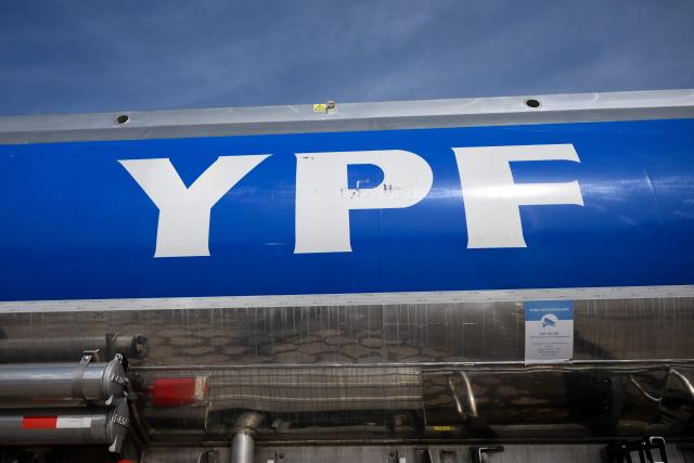 (FILES) A tanker truck with the YPF logo is pictured at a refinery belonging to Argentina's national oil company YPF in La Plata, about 60 km south of Buenos Aires, on July 4, 2025. Argentina's state-owned oil company YPF has applied to participate in a special investment program to develop oil fields in Vaca Muerta (south) at a cost of $25 billion; if approved, this would be the country's largest oil export project, the company announced on May 15, 2026. (Photo by LUIS ROBAYO / AFP)