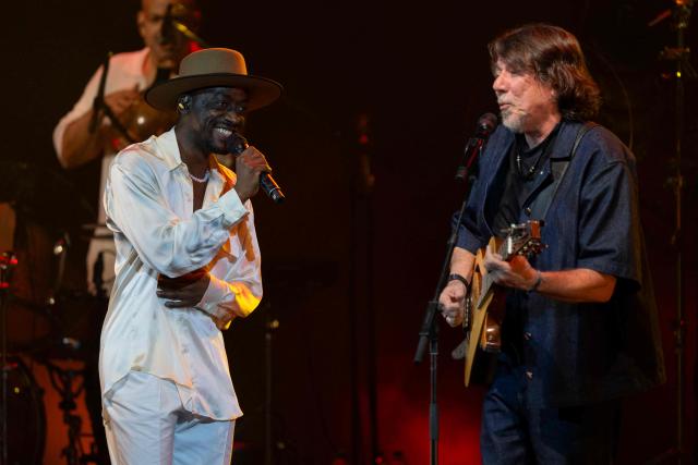Brazilian musician Jota.pe (L) and guest musician Lenine (R) perform on stage during the "Se o Meu Peito Fosse o Mundo" concert at the Vivo Rio concert hall in Rio de Janeiro, Brazil on May 15, 2026. (Photo by Pablo PORCIUNCULA / AFP)